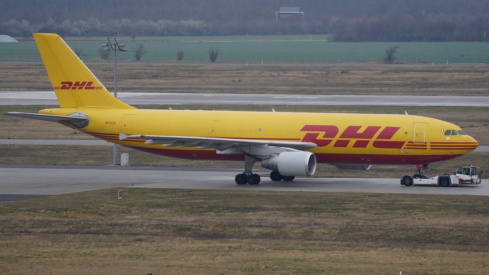 File photograph of a DHL cargo aircraft on the apron at Leipzig/Halle Airport; the pictured aircraft is not identified as connected to either reported event