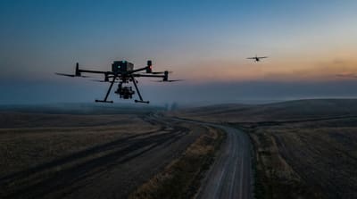 BVLOS commercial drone operating in low-altitude airspace with general aviation traffic at dusk